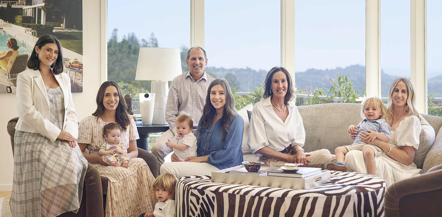 group of peole with babies posing on a sofa